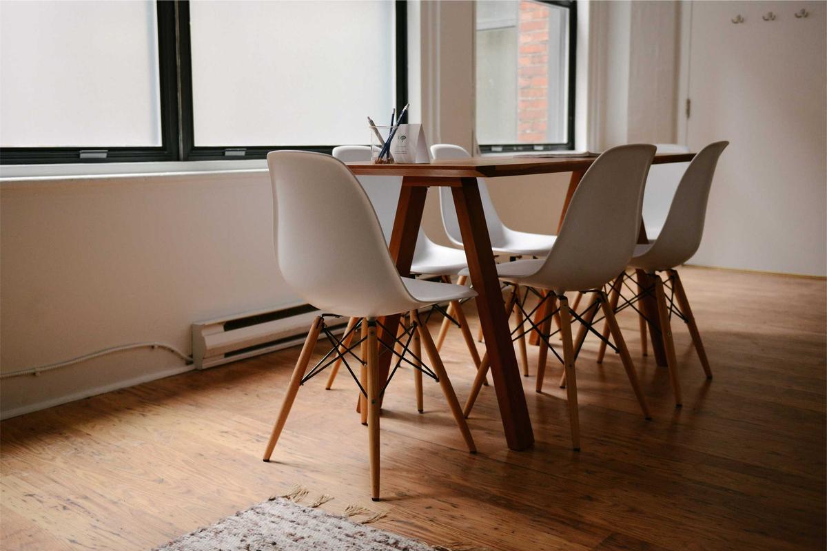 A bright room with a wooden table and chairs