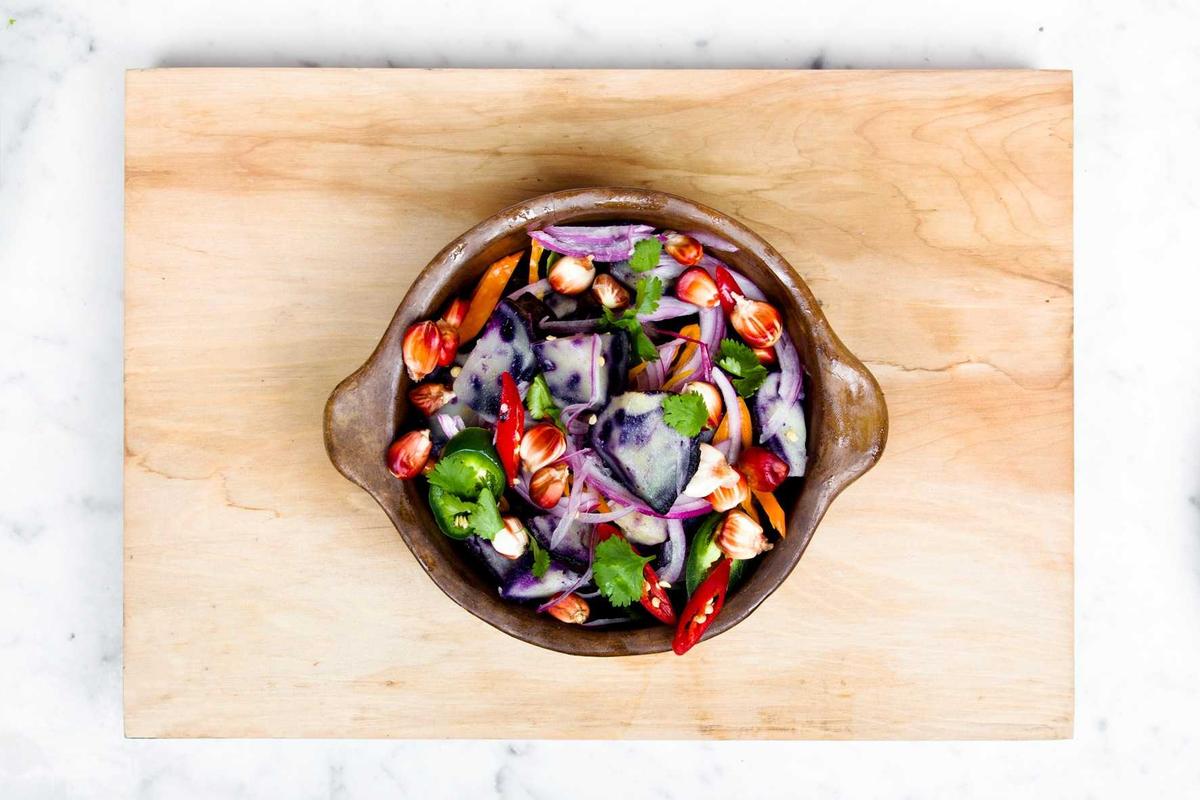A colorful salad bowl on a wooden board